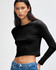 A black long-sleeve cropped fitted T-shirt on a model, featuring a logo. The shirt has a tight, sleek fit.