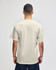 A lightweight adult jersey short sleeve T-shirt in a neutral beige colour, featuring a logo.