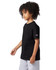 A black Champion youth jersey short sleeve t-shirt displayed on a model with curly hair, wearing grey shorts.