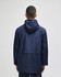 A navy full-zip anorak jacket with a hood and a back vent, featuring a logo.