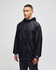 A black full-zip anorak jacket with a hood and a logo, modelled by a person standing against a neutral background.