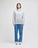 A grey full-zip hooded sweatshirt displayed on a model, paired with blue jeans. The sweatshirt features a logo.