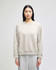 A light grey women's crewneck sweatshirt with a relaxed fit and a logo on one sleeve.