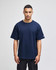 A navy blue Champion Adult Heritage Jersey T-Shirt on a model, featuring a logo on the sleeve.