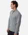 A grey men's stretch fleece 1/4 zip pullover is displayed on a model, featuring a logo.
