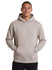 A beige kangaroo pocket hoodie with a hood and a logo on the chest. The model is smiling and standing with hands in pockets.