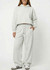 A pair of unisex wide-leg fleece pants in light grey, featuring a drawstring waist and side pockets.