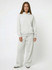 A pair of unisex wide-leg fleece pants in light grey, accompanied by a matching grey hoodie, featuring a logo.