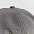 A grey cap with a perforated design, featuring small holes across the fabric. It has a rounded top button.
