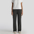 Cuffless track pants in a faded black colour, paired with a plain white t-shirt and casual footwear.