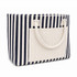 A striped tote bag featuring navy and white stripes with a solid cream front pocket and two handles.