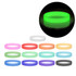 A collection of silicone wristbands in various colours, including a glowing green one, with a logo on some bands.