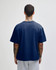 A navy blue heavyweight cotton unisex boxy T-shirt viewed from the back, featuring a small logo.
