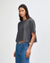 A grey cropped boxy t-shirt for women, featuring a relaxed fit and short sleeves. It has a logo on it.