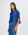 A blue cropped boxy T-shirt made of heavyweight cotton, featuring a relaxed fit and short sleeves.