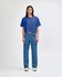 A blue crop boxy T-shirt worn with high-waisted blue jeans. The model stands against a plain background.