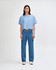 A light blue crop boxy T-shirt paired with blue jeans, worn by a model against a plain background.