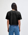 A black women's crop boxy t-shirt with a relaxed fit, featuring a simple design on the back.