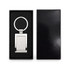 A stainless steel keytag with a rectangular frame, presented in a sleek black box with a soft interior.
