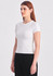 A white women's baby tee with short sleeves, displayed on a model wearing black pants. The image features a logo.