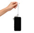 A white wrist tactile phone holder keytag is being held, attached to a smartphone and keys.