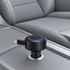 A black retractable car charger is positioned in a vehicle console, featuring a blue LED ring and a USB port.