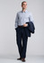 A slim fit long sleeve shirt in light blue, paired with navy trousers, featuring a jacket draped over one arm.