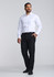 A classic fit long sleeve shirt in white, paired with black trousers, worn by a man standing confidently.