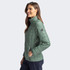 A green women's jacket with a quilted design and a logo, featuring a stand-up collar and zippered pockets.
