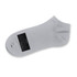 A grey ankle sock made from soft material, featuring a logo and a label indicating size.