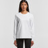 A white long-sleeve T-shirt featuring a round neckline and a logo. The model is wearing black pants.