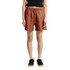 Linen dress shorts in a terracotta colour featuring an elastic waistband and side pockets, shown on a model.