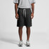 Black sports shorts with a drawstring waist, worn by a person in a grey t-shirt and grey trainers.
