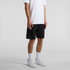 Black sports shorts with a drawstring, featuring a logo, worn with a white T-shirt and white sneakers.