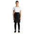 A model wearing a black linen half apron over a white t-shirt and black pants, standing straight with hands at her sides.
