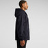 A navy zip-up hoodie displayed on a model from the side, featuring a hood and front pocket.