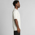 A side view of a cream-coloured t-shirt worn by a model, featuring short sleeves and a simple design.