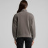 A faded grey half zip jacket with a relaxed fit and long sleeves, featuring a collar and a visible logo.