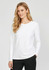 A women's performance long sleeve tee in white, featuring a round neckline and a relaxed fit. It has a logo on the sleeve.