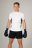 A man wearing a white and black Men's Accelerator Cool Dry T-shirt with boxing gloves and shorts.