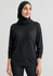 A black women's batwing sweater top, featuring a relaxed fit and long sleeves, worn with a matching headscarf.
