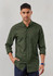 A long sleeve button-up shirt in a dark green colour, featuring a single chest pocket and a logo.