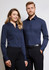 A pair of models wearing a navy blue women's long sleeve button-up shirt and a matching men's shirt, both with collars.
