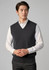 A dark grey woolmix knit vest is displayed on a model, featuring a v-neck and ribbed hem.