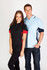 A black and red contrast polo shirt worn by a woman, alongside a light blue and navy polo shirt worn by a man. Both feature logos.