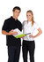 A man in a black polo shirt and a woman in a white polo shirt, both with contrasting piping, holding a folder.