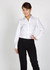 A woman wearing a white button-up shirt with a subtle stripe pattern, paired with black trousers, posing confidently.