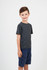 A child models a grey heather t-shirt paired with navy shorts, showcasing a casual style.