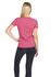 A woman wearing a pink marl T-shirt, viewed from the back, paired with dark jeans. The shirt has a logo.