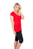 A woman poses in a red V-neck T-shirt paired with black leggings, featuring a logo on the shirt.